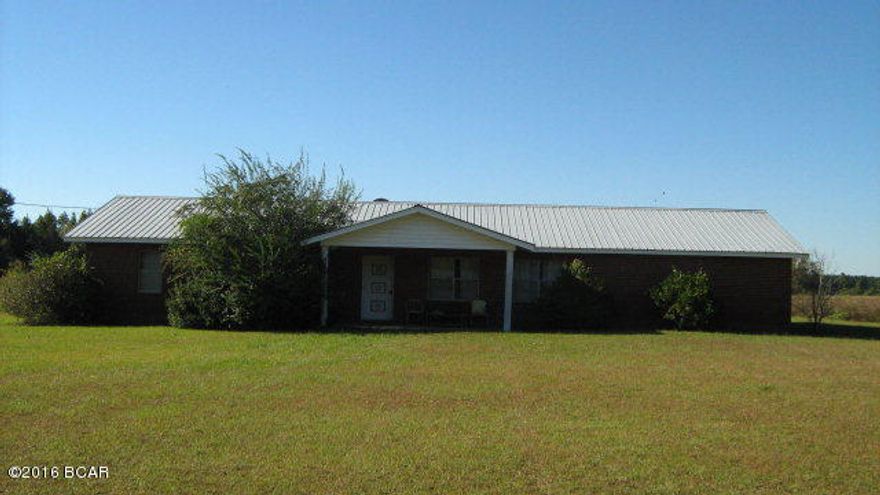GOOD 3/2 BRICK HOME WITH METAL ROOF NICE YARD AND 8.3 ACRES WITH A POND ON THE CORNER OF THE PROPERTY. HOME NEEDS SOME WORK ON THE INSIDE. THE HOME FEATURES A LARGE LIVING ROOM AND SEPARATE FAMILY ROOM WITH A FIREPLACE AND AN EAT-IN KITCHEN WITH WOOD CABINETS AND 3 GOOD SIZE BEDROOMS A SCREENED IN BACK PORCH AND A 2 CAR GARAGE. THIS PROPERTY IS PRICED TO SELL AND IT WANT LAST LONG.