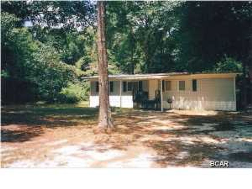 Best of both worlds: country living set back off a U.S. Hwy.; residence with commercial zoning possibilities. Mobile home on a beautiful, shady lot with tall trees and income producing property -- 3 additional lots, grandfathered-in (1957) for building or mobile homes. 1 Lot behind parcel and 2 others South of mobile home. Another continuous lot available (separate parcel): mls 620878