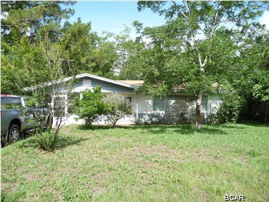 Nice clean home in Lynn Haven... 3 bedrooms, 1 bath with a large front screened in porch with new vinyl flooring, a fenced backyard, yard building.