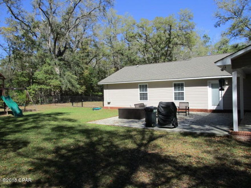 Very nice home in Bristol with large oak trees in yard and privacy in town.  This home has been kept in immaculate condition.  Every detail is in great shape from the tile floors to the stainless kitchen appliances.  The home sits on two lots with oak trees all around the large, cleared lot - plenty of room for your kids or your own toys.  There is a big swing set that stays with the home as well as a 24 x 12 metal storage shed.  The patio off of the living room is 24 x 24 and adjoins the carport.  The front yard is completely fenced in black coated chain link.  If you are looking for a good sized home with a large yard and privacy in Bristol this is it.