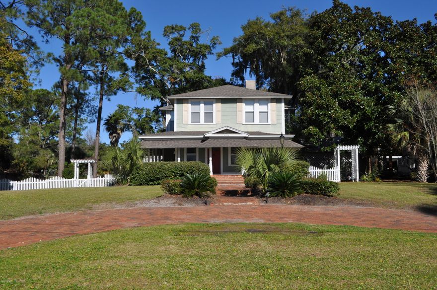 Historic St. Andrews home Circa 1900 with bay view and a separate apartment. This home was built by a Sea Captain at the turn of the century and many of the original features remain including hardwood floors, beautiful moldings and millwork, and a double sided fireplace shared by the living room and library. This home is elegant yet casual with nearly 2600 sqft of light filled rooms in the main house. The home has been updated over the years with the necessary modern conveniences without detracting from the traditional ambiance of the home. The roofs are all less than 3 years old! The main home has four bedrooms and 2.5 baths with the Master suite on the first floor. There is an office on the second level, along with loads of closets and extra storage nooks throughout the home. The apartment is approx. 600 sqft and is perfect for rental income or as a Mother-In-Law dwelling. The rambling front porch overlooks a beautifully landscaped front yard and a view of St. Andrews Bay which is just across the street. The property is nearly a half-acre and is walking distance to the St. Andrews Marina, Oaks By the Bay Park, and the historic district. Seller says he would be willing to sell the extra lot separately. All info is approx. and must be verified by Buyers if important. Seller is a Licensed Georgia Realtor.