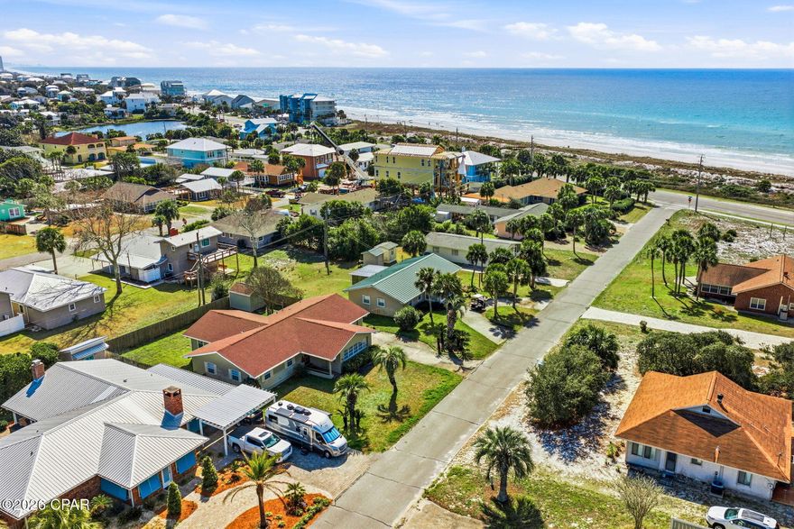 Santa Monica Beach is one of the most coveted neighborhoods in Panama City Beach for good reason, the POA owns the incredible 1,250 feet of sugar white beach in front of the neighborhood, giving residents a 4.3 acre private oasis. While other families are clamoring for beach space, the next owner of 126 Buena Vista Ave is only 350' from tranquility. Relax and listen to the waves crash on your private beach. Once you've had your fill of sun and fun on the beach, you can enjoy your charming beach home just 4 houses back from Front Beach Rd with Gulf views from the sunroom. Built in 1972 and lovingly cared for there's approximately 2,000 SF of living space with 3 bedrooms, 2 baths and 2 large entertaining spaces, the living room and sunroom in the front with views of the beach and a new family room in the back with hurricane rated windows. A huge bonus is the new roof and new septic system with drain field installed in front so the back is open for a pool. The single car garage is perfect for storing all of your beach necessities or it could be converted into an awesome bedroom with en suite. Located on the West end of Panama City Beach you're close to Pier Park and all of the amenities and in the opposite direction, the upscale shopping and dining of 30A!
