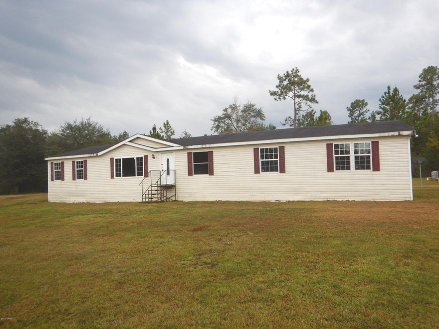 Handyman Special 4/2 mobile home situated on 5.5 acres of secluded land. This home features a split floor plan, a large living room with a fireplace and plenty of room to entertain. The open and spacious kitchen offers a panty, a breakfast bar and ample cabinet and counter space. Just off the kitchen is a large dining area with sliding glass doors that open up to a covered back porch, perfect for relaxing near your own private pond.  All Information recorded in the MLS is intended to be accurate but cannot be guaranteed, buyer advised to verify. Sold As-Is. No utilities will be turned on to this property and only cash/renovation loan offers with 0 day inspection period will be considered. Buyer should perform their due diligence/necessary inspections before submitting an offer.