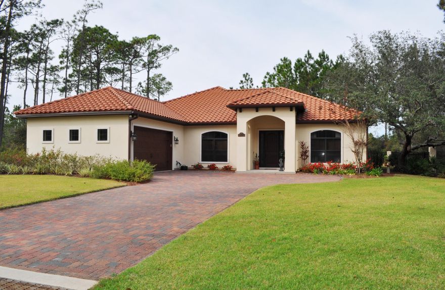 Immaculate and move-in ready Trieste home with lots of extras! This 5BR/2.5BA Mediterranean style home features 10' ceilings with crown molding, wood look tile flooring, gas fireplace, security system with cameras,  and a media room/bedroom with projector and large screen that convey! Epicureans will love the kitchen with its granite counters, glass tiled backsplash, walk-in pantry and deep oversized sink.  Cooking will be a breeze with the stainless steel appliances including a gas range, double ovens and an under counter microwave.  Thanks to a split-bedroom floor plan, the master suite has plenty of privacy and space.  The en suite has double vanities with artisan glass bowls, a large soaking tub, separate shower and a walk-in closet.  There are French doors in another bedroom that open to a patio in the backyard.  Speaking of the backyard, it is fenced and there is a long, covered lanai across the back of the home.  The property does extend beyond the fence line into Lake Trieste where you can canoe or kayak and just commune with nature!  There are many extras in this home and you will love the seclusion afforded by living in the gated community of Trieste.  The Holiday Golf Course is just a few blocks away and you're less than 5 minutes from Pier Park, schools, and the beaches!  Your hard work has just paid off.  You deserve to live in this home and community! All info is approx. and must be verified by Buyers if important. The annual HOA fee does include trash pick-up.