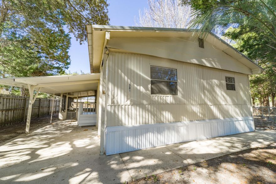 Laguna Beach only 3 blocks away from this sweet doublewide! This home sits on an awesome lot with Palmetto Pl on one side and Deluna Pl on the other side. Very cool location! Lots of neat features such as a carport, large screened in porch, large bedrooms, fenced yard and BEST OF ALL only a few blocks to Laguna beach. This home has new flooring, fresh paint, upgraded bathrooms and new window treatments. Lot of opportunities and options with this unique property. The location isn't bad either! Going east you have Carillon beach & 30A. Going west you have Pier Park, Frank Brown Park and St. Andrews Park. Now my personal favorite is south! The famous Thomas Donuts & the local market - the Carousel only blocks away. Come and enjoy the Laguna Beach lifestyle. Truly a special property.