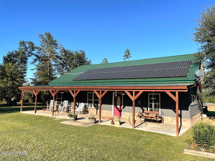 Own a little piece of paradise. Check out this custom built Barndominium loaded with extras. First there are solar panels, battery bank and controls to sell the electricity back to the utility company or if electricity goes out you can live off the panels and battery bank. There are 2 central H/C units for the home. The home has Vinyl plank flooring, sliding barn doors, open floor plan, huge master bedroom with custom tile shower. There is another small bedroom/office, one large loft that can easily be a bedroom. The second bath has the tub shower combo. The exterior of the home is stone, hardie board and metal roof. There are 11.8 acres, fenced and cross fenced, pasture, landscaped with fruit trees, hardwoods and shrubs, a work shop with lean tos, chicken coop and a separate building that can be used for man cave, another home or just storage. Come enjoy the huge front or back porch to watch the sun rise or set. Country living at it's best. Check out the photos of this custom built home.