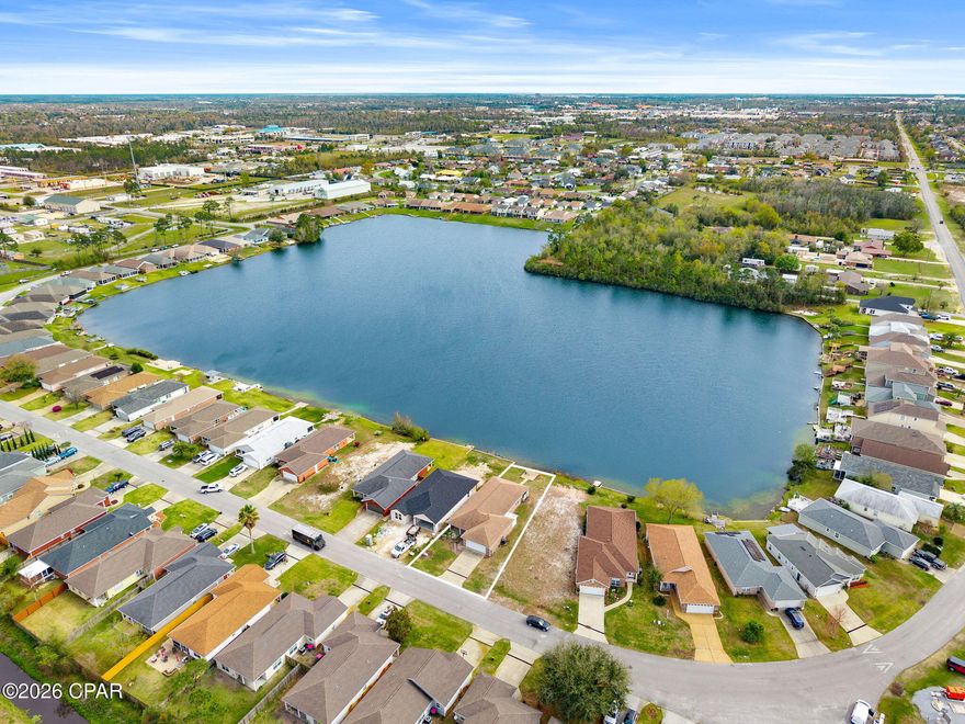 Discover relaxed waterfront living in this thoughtfully updated 3 BR / 2 BA home situated on the shores of Lake Marin, a clear, spring-fed lake tucked right in the heart of Panama City. With a central location close to everything, this home blends everyday convenience with the peaceful charm of lakeside living - all with the added peace of mind of being in a no-flood-zone area.
Step inside to an inviting open-concept living space enhanced by smooth ceilings, updated luxury plank flooring, and an abundance of natural light. The kitchen offers impressive storage and expansive countertop space, complemented by stainless steel appliances that elevate both style and function.

Thoughtful upgrades, including a newer HVAC, newer water heater, roof replacement, and hurricane shutters, ensure comfort and peace of mind for years to come.

Wake up to water views from the primary suite, featuring a tray ceiling, large walk-in closet, and ensuite bathroom. Two additional bedrooms share a Jack-and-Jill bathroom, ideal for guests, family, or a home office setup.

Designed for those who appreciate the beauty of nature, the backyard opens to the calm waters of Lake Marin, perfect for fishing, swimming, paddle boating, or simply unwinding at the water's edge. Enjoy unforgettable sunsets from your screened enclosure, offering a serene, private setting to relax and entertain.

114 Lakeridge Drive is being sold as an individual parcel consisting of lot 34.  Lot 35 is available for purchase as well. 

*All measurements and information are approximate, please verify if important.