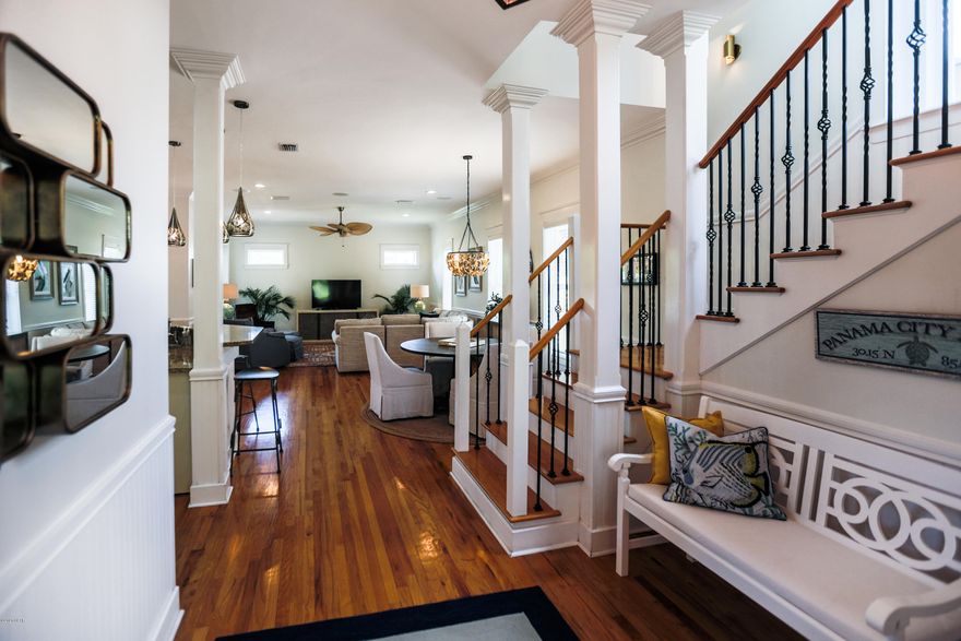 Under Contract - Taking Back Up Offers. Renovated, Super Clean,  Upscale  3 story West Indies style custom home in Prestigious Martinique Subdivision. Gated Community. Open Floor Plan.  3 bedrooms, 3 full baths plus bonus room tower on 3rd floor with views of Grand Lagoon. This home offers fabulous builder upgrades & details. Freshly painted inside, custom wood cabinets with glass doors, stainless kitchen aid appliances, new high end dishwasher & microwave,  chimney hood, new double over, granite counter tops & farm sink. New blinds throughout, new outdoor lanterns, new gate, new pavers in garden, solar lights, custom vanity in first fl master bath, new ceiling fans & all new lighting.  All wood interior doors, custom lighting package, wains coating & more. Concrete block construction on first floor, cedar siding on 2nd and 3rd floor, metal roof, 10 Foot ceilings, all wood floors, travertine in bathrooms, laundry room, front porch & patio in back yard.    Master bedroom & laundry room on first floor.  Beautiful, tropical landscaping in front and back yard.  Back yard is fenced.  This home sits in a quiet cul de sac in the back of subdivision.  Your own garage. This is a gated community with amenities including pool, playground, & walking trails. Just across the street is a marina with boat storage and launch, upscale restaurants and walking distance to St. Andrews state park. It is a 10 min ride to the World's Most Beautiful white sand beaches & emerald coastline.  Don't miss out on this one!