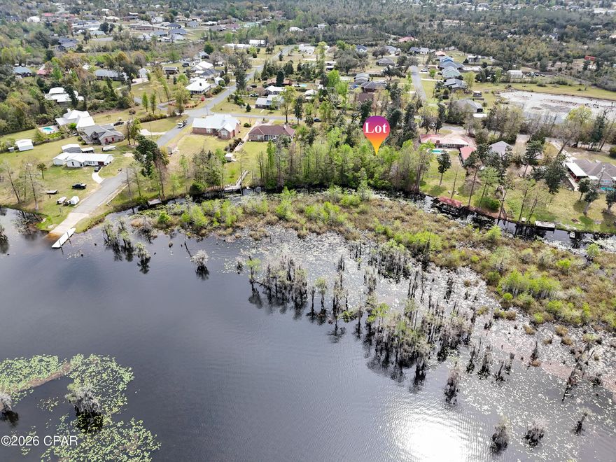 Build your dream retreat on this exceptional 0.57-acre canal-front homesite offering 100 feet of water frontage with direct access to Deer Point Lake. With serene water views & ample space to design your ideal residence, this property provides the perfect setting for a private dock, pool, workshop, or additional outdoor living features. Deer Point Lake is a 5,000-acre freshwater reservoir, formed by damming Econfina Creek, Bear Creek, and Cedar Creek, and is widely known for its outstanding fishing, boating, kayaking, and paddle boarding. Whether you envision a full-time residence or a peaceful weekend escape, this location delivers both recreation & tranquility. Conveniently situated approx 150 yards from the public boat ramp at Cedar Creek, water access is effortless. For those seeking even more space & expanded waterfront, the adjacent lot is also available, presenting a rare opportunity to own a combined 1.15 acres with 200 feet of canal frontage. This prime homesite makes an exceptional canvas for your waterfront vision with direct lake access, generous acreage, and expansion potential.