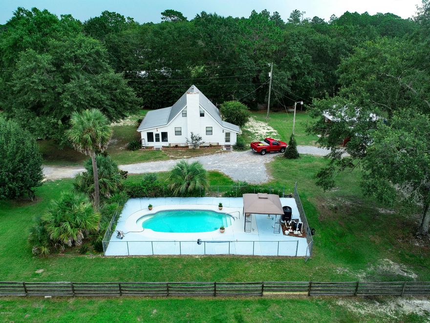 If livestock is in your future, and you still want to be close to town, then this 4 acre property may make your dreams come true. The main home has been newly updated with refinished hardwood floors, tile in the kitchen, bath, and laundry room, new paint, new stainless appliance, new glass in most windows, new well pmp, new pool pmp, and new septic system. 1 bedroom down and 2 up with 2 full bathes. Home has gas heat, hot water heater and stove. Guest house has one bedroom, office space, large kitchen/ living space, full bath and laundry, Custom cut cedar walls and ceilings, hardwood floors, Cypress in the bath/laundry rm. Kitchen has granite counters with stainless appliances. Property is fully fenced, with two separated pastures, fenced pool area. Also boasts remote controlled gate.