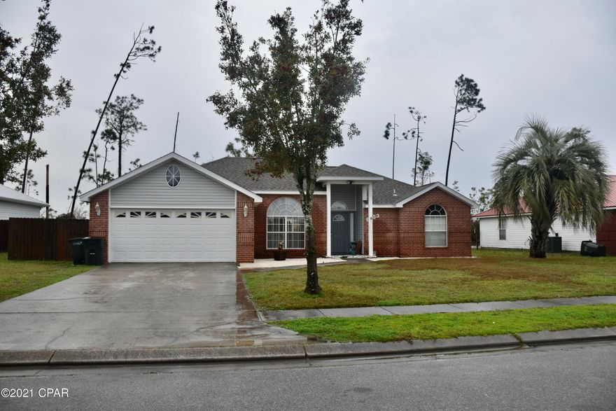 Check out this beautiul, spacious 3 bed, 2 bath home on .23 acres in Callaway. Only minutes to Tyndall AFB, shopping, restaurants, boat launches; and less than 30 minutes to the private beach on Tyndall or Mexico Beach! This home offers 1945 sqft with a large living room area (10 ft ceilings), dining area, and split floorplan.  Hardwood flooring is felt throughout with seemless transitions. Enjoy those cool winter nights in front of your wood burning fireplace or relax in your beautifully renovated Florida room! This home comes with storage inside as well as outside; drop down stairs allow access to above garage storage, and the yard is set with a 12 x 8 storage building ... perfect for yard tools, toys, or holiday decoration. No HOA and this home is not in a flood zone. Home has new siding, new roof (1.5 years old), new paint, as well as fully renovated Florida room.  The large backyard is completely enclosed by a wooden privacy fence, providing safety and security for your children or pets. Finally, take time out to relax or entertain by the outdoor patio area ... perfect for grilling, sunbathing, or simply an outdoor dining area. Home is on seperate meters for city water and irrigation.  This home has it all! Call for your private tour today ... it won't disappoint! Measurements approx; verify if important.