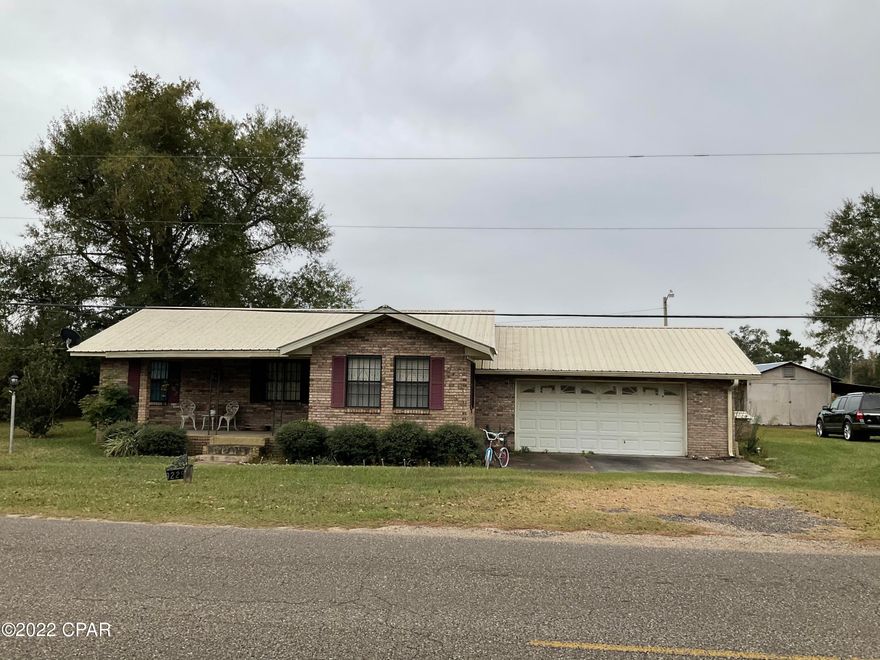 *CURRENTLY UNDER CONTRACT, SELLER WILL CONSIDER BACKUP OFFERS* Well maintained brick home with acreage located less than 2 miles from town on a corner lot. This 3 bedroom 2 bath home with family room that has a fireplace and sliding glass doors that open up to a large brick patio that has brick BBQ grill. There is a storage shed with lean too, all with concrete floor and wired with lights and outlets. A second storage shed as well as another septic tank where you could put a mobile home for rental purposes or just put  another home. This home just needs someone to move in and love it or remodel and update it and make it your own. So much potential!