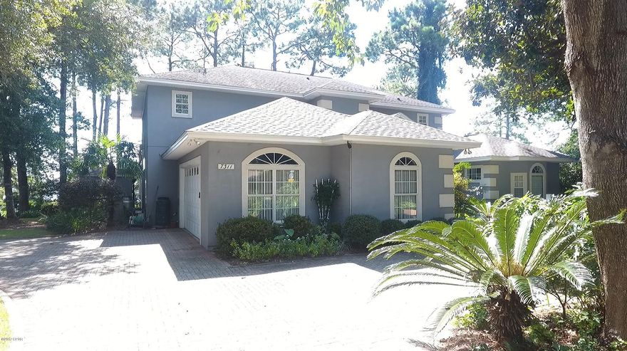 A dream home surrounded by lush tree scapes overlooking Grand Lagoon with dock, boat house and 10,000 lb. lift. Deep water all the way to the pass. Homes features master bedroom downstairs, large living room and modern open kitchen with pickled cabinets all with views of the Lagoon Den also located downstairs. A screened porch allows you to dine outside without pest!  Second floor has 3 bedroom all with balconies and an offices. Wood floors in home, carpet in  bedrooms. Additional energy saving features of this home include 2 geothermal closed loop heat pumps with heat recovery to 80 gallon Marathon water heater. Energy Select controls to allow you to select how much you pay for electricity at certain hours of the day. Average monthly power bill $117.84 for a home with almost 3900 sq.ft Roof has been replaced with 50 year shingles by Sittie Roofing 2/10/18.