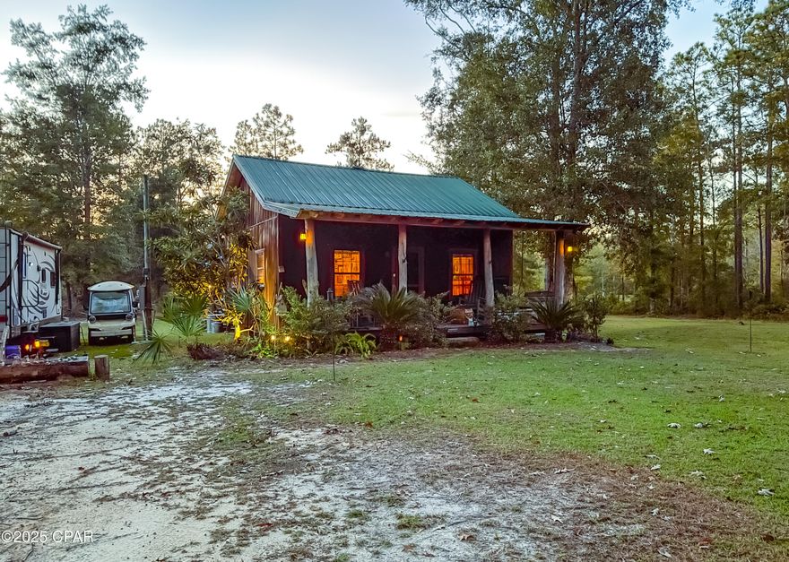 !!Price Improvement!!

Tucked away in the heart of the Apalachicola National Forest, 38134 SW Forest Road 123 in Bristol, Florida offers a retreat surrounded by 18 acres of natural beauty. Built in 2008, this cozy cabin blends rustic charm with everyday comfort. The layout includes a versatile open-concept living, dining, and kitchen area, plus a loft that adds flexible space for relaxing or sleeping.

Step outside and you'll find thoughtful touches made for enjoying life outdoors, like the screened-in cooking shed where you can prepare meals and share stories with family, or unwind on the covered front and back porches while listening to the sounds of nature. The property also features a pole barn, RV hookup, WiFi service for staying connected, and a fire pit area perfect for cool evenings under the stars.

Surrounded by endless forest, this property is a paradise for those who love to hunt, fish, or simply just disconnect. Yet, it's conveniently located just 45 minutes from the sugar-white sands of St. George Island and an hour from Tallahassee.

Whether you're looking for a weekend getaway or a full-time retreat, this cabin lets you slow down, recharge, and reconnect with the outdoors.