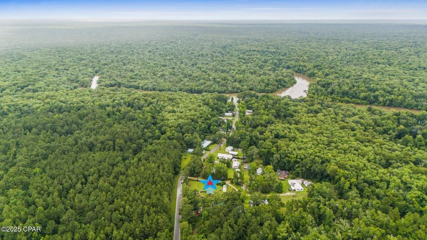 Welcome to Bryant's Landing! This quiet and laid-back community boasts easy access to the Chipola River. Excellent fishing and 1,000's of acres of undisturbed, Northwest Florida Management land.  Perfect for Hunters, Fisherman, and outdoor enthusiasts. This Barndominium is quaint and cozy, custom built in 2022. A nice sized double lot at .60 of an acre. Upon entering, the front porch is the first thing to catch your eye. It is the perfect place to enjoy your morning, and the spot the current owners will miss the most. It's a small cozy home but has a big feel, with 12ft vaulted ceilings in the main space. It is bright and airy, with plenty of natural light. The kitchen features solid wood custom cabinetry and a pantry. Luxury vinyl plank throughout. The Master is spacious and has loft that is perfect for kids or grandkids It also has a nice walk-in closet and several built-ins for storage. You really must see to appreciate the thought and attention to detail when creating this place. Once outside you have a detached garage with laundry hook-up and a sink. A storage building with a half-bath, and another building for storage. The yard is partially fenced for pets. Fruit trees such as orange, tangerine, and grapefruit. Only 1300 feet to the Chipola River and boat launch, but just far enough to be out of the flood zone. Head out fishing or just a peaceful cruise down the river on a pontoon. Excellent overall proximity as well. Just 30 minutes to Mexico Beach, 25 minutes to Port St. Joe, and 35 minutes to Panama City. Community water and sewer. Schedule your visit!