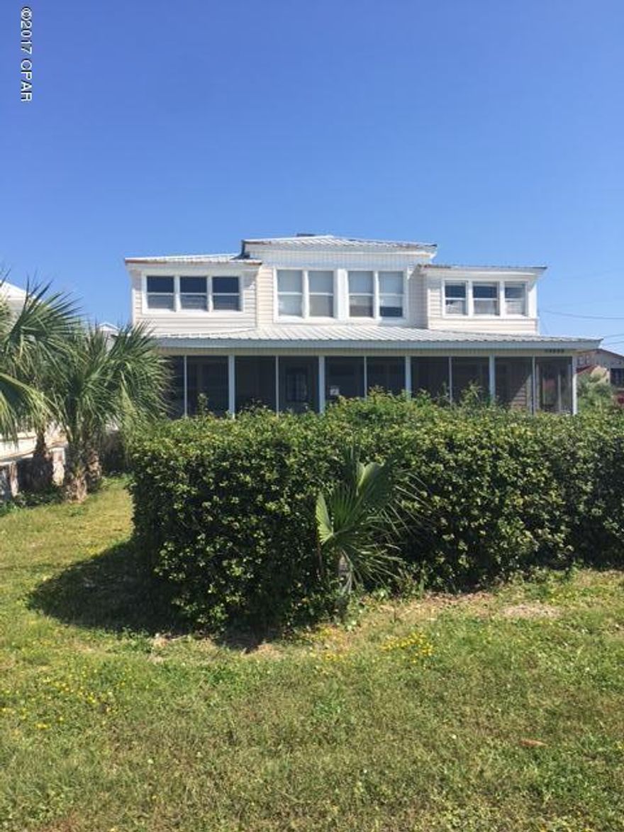 HUGE lot directly across the street from a DEDICATED Beach -- sweeping unobstructed gulf views. Build your dream home here on the desirable West End of Panama City Beach, just a block West of the Carousel Market and only about 3 miles to Pier Park with all the restaurants and shopping! The home that sits on this property needs a lot of work -- and the value in this property is in the LOT -- and its fantastic location with unbelievable gulf views.