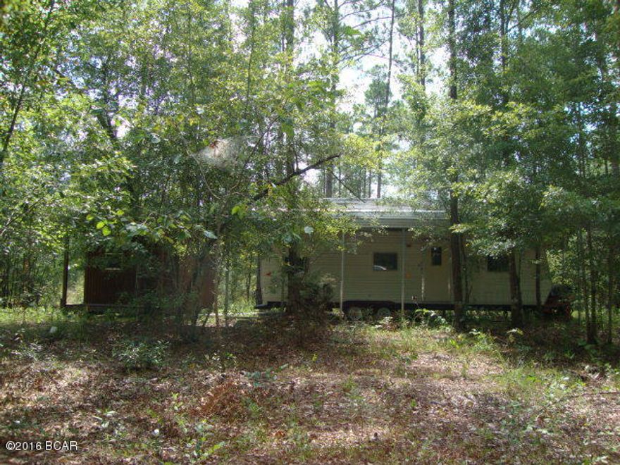 40 Acres of land. Great hunting camp or nature getaway Already has a camper, covered shelter, outbuilding, well, septic and power. Mostly wooded but cleared area around the camper and improvements. Lots of cleared nature trails throughout the property. Lots of wildlife to include deer, hog and turkey. Some of the low lying area may even include some duck hunting. Lots of county maintained dirt road frontage and not far to paved county road. About 8 miles from town. If you want peace and quiet then this is the place. This is absolutely a great get-a-way and a hunter's paradise. Check it out today!!!