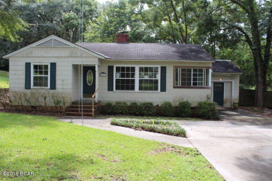 What a find! This cute cottage style house sits on a corner lot in town with city water and sewer. It has nice hardwood floors and a large living room with a fireplace. There is a sunroom and another extra room just right for a hobby or work room by the utility room that is equipped for washer and dryer. You have a large privacy fenced back yard! Make appointment now to see this little jewel.