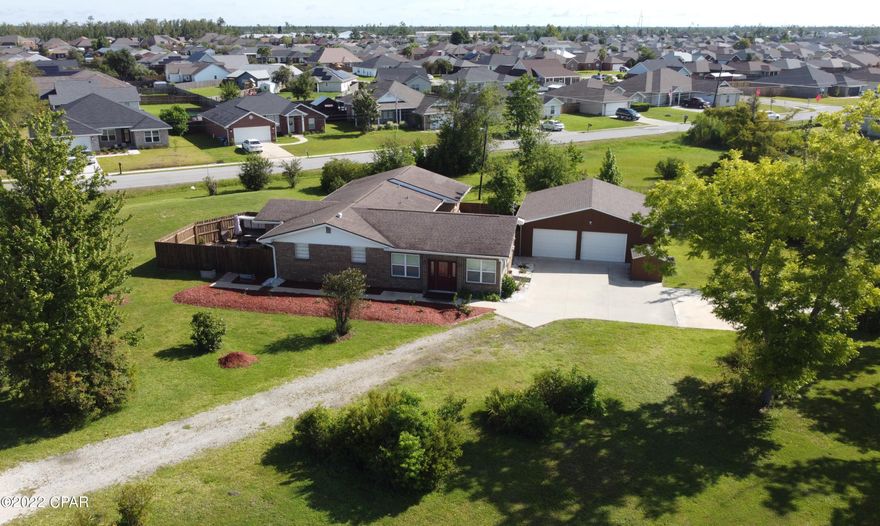 An amazing all brick 3//3 featuring the perfect blend of privacy and proximity, almost an acre and centrally located. Enter into a spacious living room with plenty of natural light. Beautiful kitchen with plenty of cabinets, granite counter tops, and stainless steel appliances. Breakfast bar, a walk-in pantry, and a coffee bar. Formal dining off kitchen. Home features 2 master suites. The main master has direct entry to an amazing outdoor space. It offers a huge custom shower with two heads, double vanities, and an incredible walk-in closet with built-ins. The 2nd master also has double vanities and a shower/tub. Guest room is spacious and guest bath has a custom tile shower and is handicap accessible. Outside there are 2 outdoor spaces both with fire pits, pavers, and sinks. Perfect for entertaining family and friends. Over sized 2 car garage with plenty of room for tools and cabinets and will fit 2 cars comfortably. Also a 17x17 covered parking space with a sink and 12x24 workshop, a perfect spot for a cookout or to park a boat. Spacious property has a pear tree, grapefruit tree and blueberry bushes. Full camera system conveys. Pride of ownership shows throughout this home. Schedule your visit today!