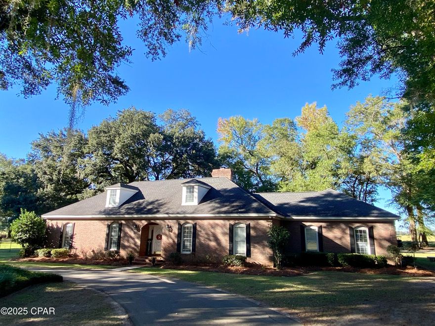 Welcome to 4620 Oakwood Drive - A beautifully maintained 4 bedroom, 3.5 bath brick home that sits on a corner lot in the desirable North Oaks subdivision.  From the moment you arrive, the front circular driveway, shaded by a canopy of mature oak trees, creates a grand and inviting entrance.  
Step through the front door into a stately foyer featuring high ceilings, elegant woodwork and an arched doorway that leads to the living room. The living room boasts custom built-in bookshelves, a cozy fireplace and French doors on either side that allow for abundant natural light.

The kitchen offers plenty of cabinet and counter space, an island with a cooktop and stainless steel appliances. Enjoy casual meals in the charming breakfast nook, highlighted by decorative stained-glass windows.  The formal dining room is the perfect place to host special gatherings.  
The spacious master bedroom features arched doors that goes to a large en-suite bathroom with double vanities and built-in his & hers chest of drawers.  Two additional bedrooms, a full bath and a half bath are also located on the main level.
Upstairs, you'll find a second master suite complete with its own private bath, along with a flex space currently used as a playroom—perfect for guests, teens, or a home office.
Outside, the fenced backyard offers peace of mind for kids and pets, while the back patio is ideal for entertaining or simply relaxing as you enjoy beautiful Florida sunsets. The two-car garage, accessed via a separate driveway, adds both convenience and curb appeal.
Located just minutes from Marianna K-8, Marianna High School, Chipola College, the MERE Sports Complex, and Florida Caverns State Park, this home combines comfort, convenience, and classic Southern charm.
Don't miss your chance to make this exceptional home yours!