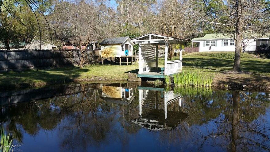 Everything you have been looking for in a home.  You have the feeling on being out in the country but you are only around 12 miles from the Panama City Mall. This home has an open airy feel with a large living, dining and kitchen

area. The kitchen features a new refrigerator, dishwasher and microwave.

In 2013 a 15 seer air conditioning unit was installed. The master bedroom has 2 walk-in closets! The back yard features a large deck that over looks the playhouse, gazebo, and fish pond.

There is also a large chicken coop and chicken run. Fresh eggs! The 20'X30' garage gives plenty of room for parking and a workshop area.  Make an appointment to see this hidden treasure today!