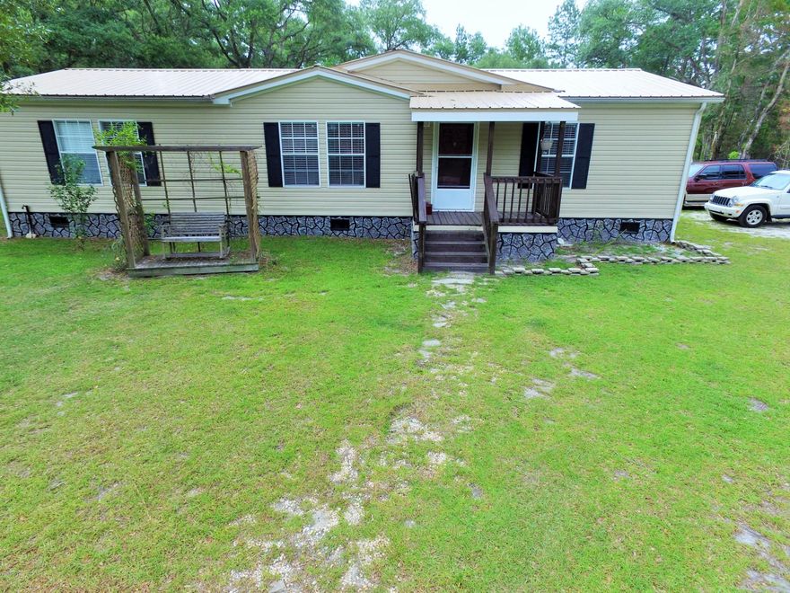 If you are looking for a home in the country that is private with loads of wildlife on it.  THIS IS IT! Very nice 3/2 doublewide located on 5 acres and surrounded bay nothing but woods.  Home has a open floorplan with a beautifully laid out kitchen area.  Attached two car carport, 12x20 attached with electric and additional attached pole barn behind shed.  There are many hunting trails already cut and the owner has scored some BIG bucks over the past couple of years.