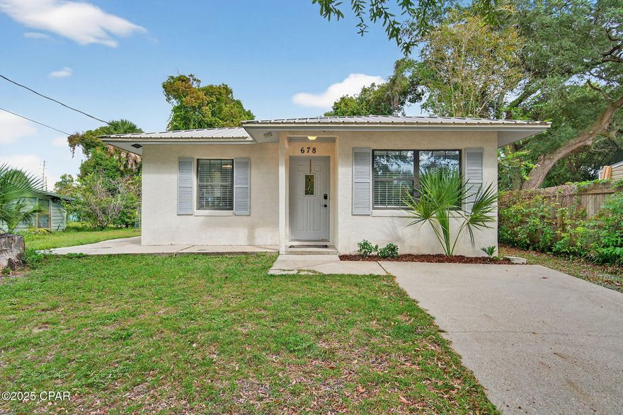 CURRENTLY UNDER CONTRACT, SELLER WILL CONSIDER BACKUP OFFERS. Charming 2-bedroom, 2-bath home located directly across the street from Watson Bayou. Conveniently located near downtown Panama City, Florida, this property is ideal for a short-term rental, long-term rental, or Airbnb investment. Featuring a metal roof and an inviting open floor plan, this home includes a spacious living and dining area that flows into the kitchen. The primary suite offers a walk-in closet and private bath. A sliding glass door opens to the patio and fenced backyard with storage shed, perfect for outdoor living.