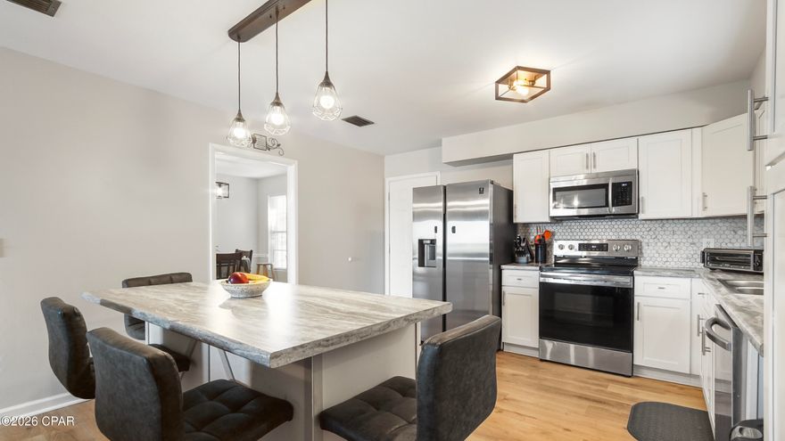 This inviting property combines modern comfort with relaxed charm on almost 1/2 an Acre. Just minutes from Tyndall Air Force Base, shopping, dining, and the white sandy beaches of Panama City Beach & Mexico Beach.

Step inside to find a bright, open-concept floor plan through the foyer that allows for easy living and entertaining. Featuring 2 separate living spaces, one with a brick wood burning fireplace, and a dedicated dining room. The home has spacious bedrooms, updated finishes, and a well-appointed kitchen with plenty of storage and counter space. Sliding glass doors open to the large back yard with a wooden deck overlooking the space, making this home inviting for everyday living and for guests to enjoy. Stainless appliances.