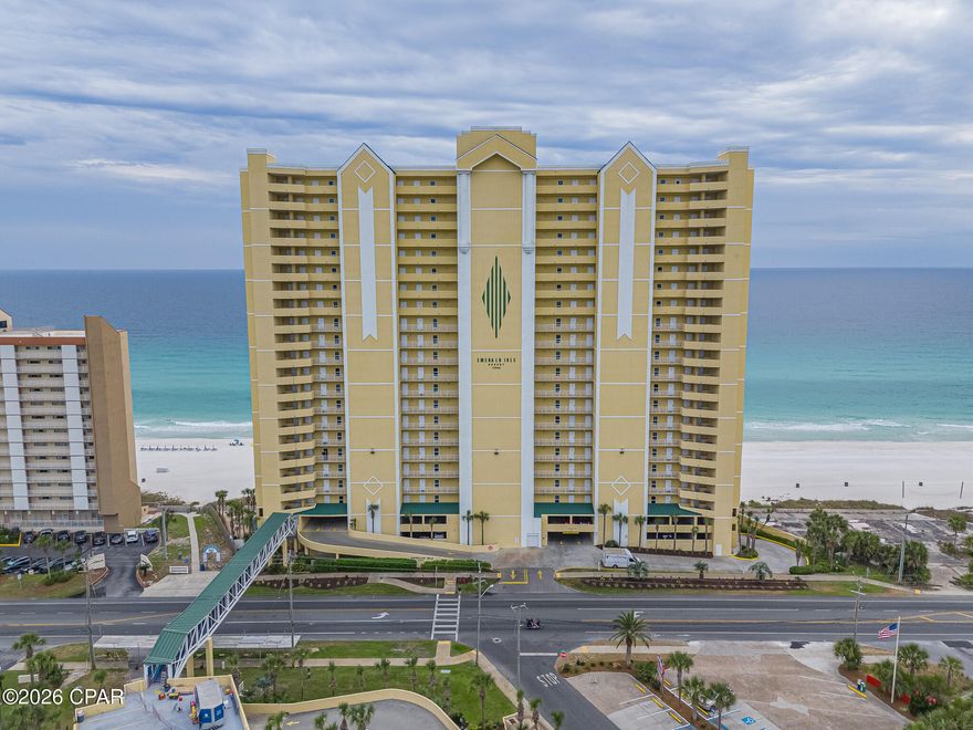 DEEDED PARKING SPACE INCLUDED. This spacious, bright Gulf-front condo at Emerald Isle offers the ideal mix of personal beach retreat and income-producing investment, previously averaging approximately $58,000 in annual gross rental revenue, making it perfect to enjoy part-time while helping cover costs and generate cash flow. The open layout features 9' ceilings, crown molding, luxury vinyl plank flooring, and abundant natural light, with seamless flow between the living, dining, and kitchen areas centered around Gulf views, while the kitchen includes granite countertops and a breakfast bar. A standout feature is the oversized 10.5' x 28' curved Gulf-front balcony with panoramic coastline views, accessible from both the living area and the Gulf-front primary suite, and each bedroom offers private bathroom access for added comfort. Recent updates include a new HVAC (Nov 2024) and 2020 water heater, along with a stacked washer/dryer, exterior storage closet, and deeded parking space located just steps away from the elevators. Residents enjoy resort-style amenities including Gulf-front pools, hot tubs, steam room, fitness center, and covered parking, with HOA fees covering everything except electricity and pet-friendly ownership. Located on the west end of Panama City Beach just minutes from Pier Park, dining, and entertainment, this condo offers both convenience and a laid-back coastal lifestyle.