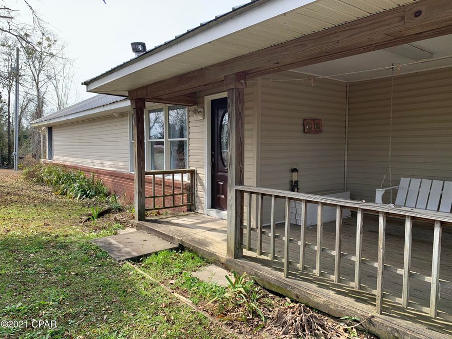 Spacious wide-open 5 bedroom 3 bath home on a beautiful gently sloping 6 acre lot, overlooking a fully stocked pond.  This home features a spit floor plan with a large open living, dining and kitchen area.  Each bedroom is spacious and well thought out with plenty of closet space and natural light.  The master bedroom has beautiful built-ins leading into the bath and a large window overlooking the back yard and pond.  The home also features a 2018 metal roof, two water heaters and an 80 Kw diesel 34-gallon generator.   The back of the house features screened and open porches with a beautiful stoned courtyard complete with a space for an herb garden and rose bushes, your own secret garden oasis.  The garage and workshops are a must see, complete with a kitchen, full bath and a bedroom for your guest, a decked loft for tons of storage and nice work benches to complete any project. Garage also includes 4 new roll up doors for maximum storage of equipment large and small. Also included is a RV sewer, electrical and water hookup.  Did I forget to mention the chicken palace and all the beautiful fruit trees.  There's too much to list, so make an appointment today to see all this home has to offer.