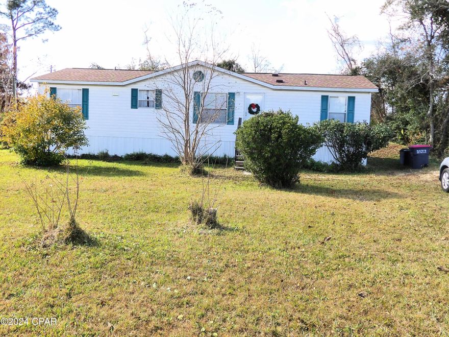 Close to Lynn Haven but still in country, Three Bedroom two bathroom manufactured home in Great condition on a larger lot offered as it.  The home features a kitchen dining room area., nicely landscaped front and back an is close to Southport Elementary.  Call for your private showing today.