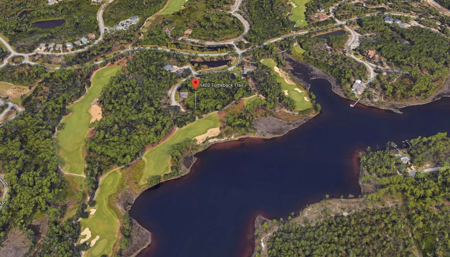 This is a Premier lot with views of the lake and it edges the Greg Norman designed, Sharks Tooth golf course. Lot is at the end of a cul de sac and backs up to fairway 6 par 5, to give you an expansive view of both the golf course and beautiful Lake Powell, which is one of the largest Coastal Dune Lakes in the country. The back of the lot widens to allow an incredible view from a future home.  Other amenities include Gated and guarded entrance, the lakeside pool with heated whirlpool, fitness center, outdoor fireplace, fire pit, barbecue, dock, fishing, boathouse, kayaks, canoes, trails and owners library. Perfect family neighborhood!  Purchasing in Wild Heron allows the buyer to become a member of The Clubs by Joe, if they wish to.