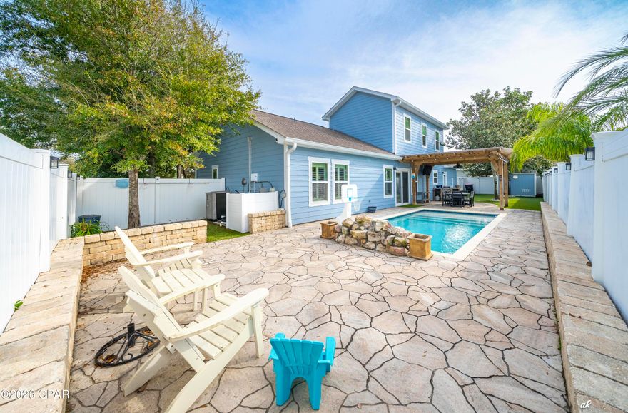 Come discover the Ocean Mist subdivision, a hidden gem in the heart of Panama City Beach. This quiet, gated community of 24 craftsman-style homes offers a secluded community swimming pool, shaded pergola for gatherings, sidewalks for walking, and underground utilities - all adding to its unique appeal. The ''Sandstorm'' model features a downstairs master retreat, custom cabinetry in both kitchen and bathrooms, granite counter tops throughout, upgraded fixtures, breakfast bar, bar in dining area with wine refrigerator and ice maker, stainless steel appliances, laundry room, custom tile shower in master, double vanity, and large walk-in closet. 
Relax or entertain in your PRIVATE BACKYARD RETREAT, FEATURING A HEATED SALTWATER POOL WITH A SUN SHELF AND WATERFALL, a covered patio, and an outdoor kitchen complete with a grill. The elegant flagstone decking, easy-care turf, and spacious 10x8 storage building add both style and convenience to the space. Additional home upgrades include freshly painted interior and exterior, closet organizers in Master and upstairs bedrooms, epoxy flooring and mini split HVAC in garage, separate golf cart garage entrance, plantation shutters throughout, sprinkler system, rain gutters, and hurricane shutters. This property is conveniently located within walking distance or a short golf cart ride to the world's most beautiful beaches, and just minutes from Pier Park, popular restaurants, golf courses, and shopping areas. The quarterly Homeowners Association (HOA) dues include weekly trash service and access to the community pool. This charming home won't last long, schedule your showing today and make it your perfect beach retreat! All information is approximate and should be verified by buyer if essential.