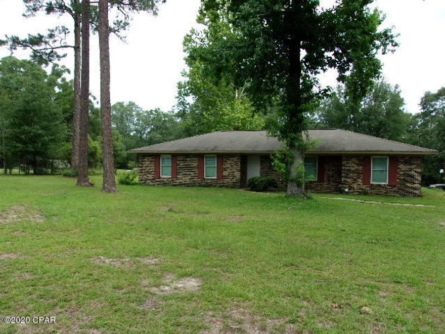 CURRENTLY UNDER CONTRACT SELLER ACCEPTING BACK UP OFFERS  - 3 bedroom 2 bath brick home on 1.58 acres on Edge of city limits. Renovated over the years.  Has living room and separate den. Nice country kitchen with lots of cabinet space and newer counter tops. Tile floors. Good sized laundry room with room for freezer. Spacious bedrooms. 2 car carport. Large back porch/deck great for cook outs. Storage building. White picket fence across the front.  Frontage on paved road. Room for a small garden. Close to schools. Convenient to shopping and churches. New metal Roof.