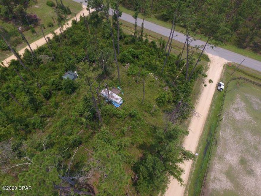 Full or Part time living close to the Chipola River.  Private Boat ramp use for all owners of the subdivision.  Three road access to the property.  Close proximity to the Scotts Ferry Volunteer fire dept.  Shallow well, temporary power pole and hurricane damage camper on the property that the seller does not warrant.  Driveway to the property is on Blue Bream Dr.