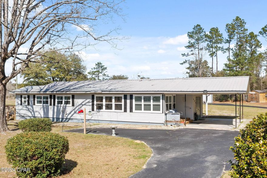 Located on the highly desirable Clayton Road sits this 2-bedroom, 2-bath home perfectly situated on 1.76+/- acres! As you enter, you'll be greeted by a spacious foyer serving as a welcoming space for guests, a cozy living room ideal for relaxing evenings spent unwinding with loved ones and a kitchen that is thoughtfully designed to maximize functionality and efficiency.  The master bedroom offers a peaceful sanctuary, complete with an ensuite bath, walk-in closet/nursery and direct access to the side porch, where you can enjoy your morning coffee or bask in the tranquility of the outdoors. Upgrades abound throughout the home, including all new windows with tint for added energy efficiency and privacy, a whole house generator for peace of mind during power outages, and spray foam insulation under the house for enhanced comfort and energy savings. Outside, you'll find a paved circular driveway, attached carport, enclosed rear porch filled with an abundance of natural light, fenced back yard, pole barn providing the perfect storage solution for an RV or camper and a steel framed workshop equipped with roll up doors, insulation and lean-too for all your DIY projects. Home is conveniently situated near Falling Waters Road, a short drive to Hwy 77 and Interstate 10.