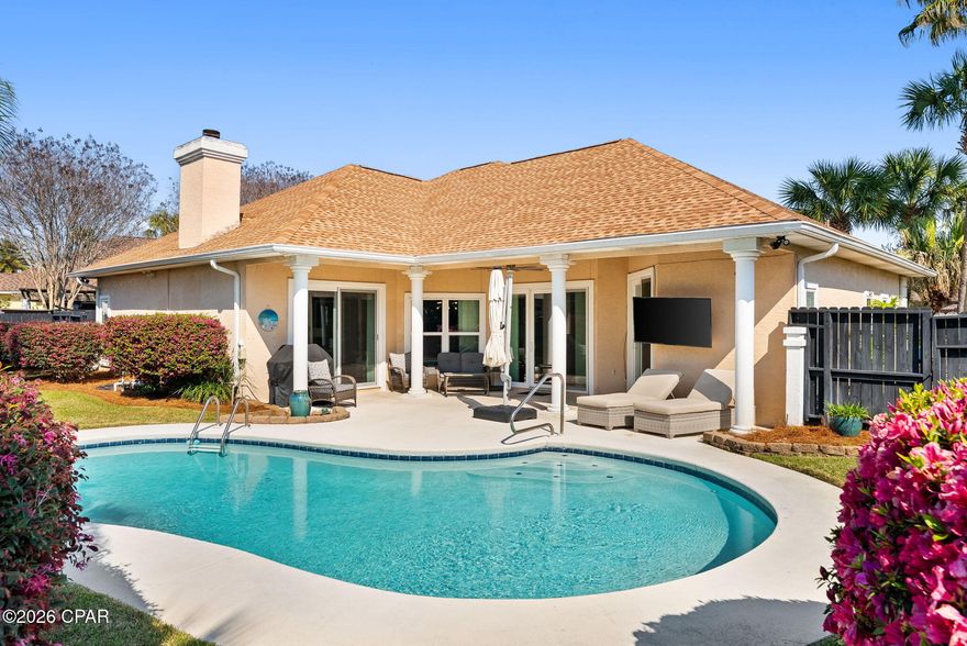 Welcome to Palm Bay! This exquisite pool home is located close to the entrance with easy and quick access to the beach, shopping and restaurants. The beautiful landscaping and palms create a coastal vibe while relaxing out by the pool and patio area that is sure to impress. This home has tasteful lighting throughout, LVP flooring, a fireplace, updated impact doors and windows that allow lots of natural light and custom window treatments. 
The spacious primary suite has sliding glass doors that lead to the pool and patio area.  The primary bathroom includes a large walk in closet and has been renovated with a custom tile shower, soaker tub, quartz countertops with double vanities and a private water closet. The split bedroom floor plan includes two bedrooms and a bath with an additional two bedrooms that can be used for dining, office or play room as well. The kitchen contains stainless steel appliances and has been renovated with modern quartz countertops, wood cabinets, gorgeous hickory island and venthood and a custom pantry for plenty of storage.  This home has so much to offer and some extra features include two car garage, ring doorbell system, washer and dryer, roof (2020), new well pump for irrigation system with wifi control, privacy fence, natural gas hookup for grill area, close proximity to the mailbox area, built in book shelves and cabinetry in the living room, hybrid heat pump water heater (2021) and many more. Don't miss your chance to enjoy beautiful sunsets out by the pool in your own back yard! All information and measurements are approximate, buyer to verify if important.