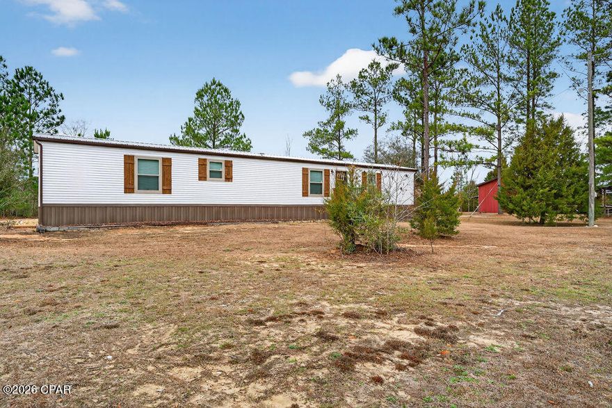 Escape to wide-open space and endless possibilities with this 2024 single-wide mobile home situated on just over 60 acres of beautiful land. Tucked away for privacy yet offering paved road frontage, this property backs up to thousands of acres of Water Management land and a wildlife refuge, creating a true outdoor paradise. Enjoy frequent visits from quail, turkey, and deer, making this an ideal setting for hunters, nature lovers, or anyone seeking peaceful country living.

The land is already set up for a self-sufficient lifestyle with grapevines, fruit trees, and raised-bed gardens ready for your homesteading dreams. Whether you envision a hunting retreat, mini-farm, or private getaway, the possibilities here are truly endless.

The home offers comfortable living with a nice covered back porch overlooking the property and an above-ground pool perfect for cooling off after a day outdoors. A 25x56 barn adds exceptional versatility, featuring a large open area with cabinets and a fully enclosed bedroom, providing space for guests, storage, a workshop, or hobby area.

If you've been searching for acreage, privacy, and room to create your ideal country lifestyle, this unique property is a must-see.