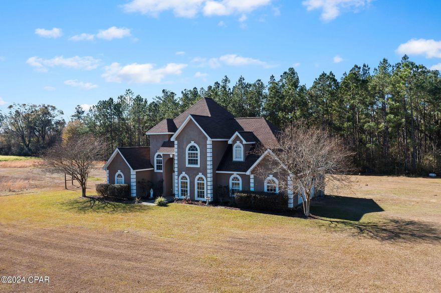 Situated on 4.5 +/- acres sits this elegant custom designed home where comfort, nature and lush living intertwine. Walk through the front door and you are immediately greeted with towering cathedral ceilings, formal dining room, living area filled with an abundance of natural light and an eat-in kitchen featuring breakfast bar and hickory cabinets. Also located on the main level is a spacious master suite which boast a large walk-in closet, his/her sinks, jacuzzi tub and renovated shower. Upstairs you will find 2 additional bedrooms, full bath and 11x18 bonus room that could serve as a 4th bedroom. Outside features include attached 2 car garage, fenced area for horses/livestock, massive back porch for entertaining guest and detached storage building. Property is located on a quiet corner lot just east of Chipley.