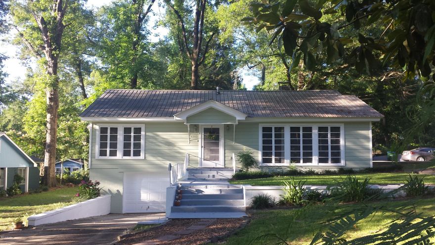 Vintage charmer loaded with character. This 2 bedroom, 1.5 bath home is located on a peaceful tree lined street in the heart of Marianna. Floor to ceiling windows to enjoy lovely surroundings, a screened back porch for enjoying summer afternoons, and your morning coffee or tea. Fireplace in the spacious living room for when the cool nights return. Hardwood floors, warm woods, and lots of built-ins. Make this bungalow your own! EXTERIOR HAS BEEN FRESHLY PAINTED!!