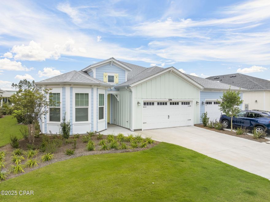 Brand New NEVIS villa.  2 Bonus Rooms/Den/Hobby! 
Welcome to your slice of paradise in the Jimmy Buffett-inspired 55+ community of Latitude Margaritaville Watersound! This beautifully appointed 2-bedroom, 2-bathroom villa comes with an impressive $94,000 in premium upgrades that transform this space into something truly special.

Step inside and you'll immediately notice the attention to detail throughout. The whole house features impact doors and windows for peace of mind during storm season, plus custom Reserved White paint and elegant aged bronze door hardware that gives every room a cohesive, polished look. Crown molding in the common areas and gorgeous faux wood blinds add those finishing touches that make a house feel like home.

The heart of this home is undoubtedly the stunning kitchen, where cooking becomes a joy rather than a chore. Granite countertops provide plenty of workspace, while the upgraded backsplash adds visual interest. The KitchenAid French door refrigerator with platinum interior keeps everything fresh and accessible. Under cabinet lighting illuminates your culinary creations, and thoughtful storage solutions like pull-out shelves and pots and pans drawers keep everything organized. The island features flat panel details that complement the soft-close cabinets throughout.

The primary bedroom suite is your personal retreat, featuring an alternate bathroom layout with a seamless shower enclosure and convenient corner ledge. Quartz countertops and level 3 floor and shower wall tile create a spa-like atmosphere, while the oil rubbed bronze fixtures add warmth and character. A designer ceiling fan keeps things comfortable year-round.

The second bedroom also boasts quartz countertops and level 3 floor tile, maintaining the home's high-end aesthetic throughout. The dedicated hobby room with solid French panel doors and recessed lighting gives you space to pursue your passions, while the den with French glass doors offers flexibility for whatever life brings.

Your outdoor living space is equally impressive with an extended, screened and paver lanai perfect for morning coffee or evening cocktails. The outdoor ceiling fan and strategically placed outlets for lighting and television mean you can truly live the outdoor Florida lifestyle in comfort.

Practical touches make daily life easier too. The laundry room features stackable LG ThinQ Smart electric units, upper and lower cabinets with sink, and granite countertops for folding. The whole house WiFi upgrade package keeps you connected, while the dedicated 20-amp garage outlet handles whatever projects you have in mind.

Throughout the home, silverstone chestnut laminate flooring provides durability and style, while all tile and granite have been professionally sealed for longevity. Power blinds at the front door and remote blinds at the sliders add convenience and privacy control at your fingertips.

The great room and family room feature recessed lighting and designer ceiling fans, creating comfortable gathering spaces for friends and family. Every detail has been thoughtfully considered and professionally executed, as confirmed by an independent third-party inspection completed after close with all items completed by Mastercare.

This isn't just a house - it's your ticket to the relaxed, resort-style living that makes every day feel like a vacation in paradise.