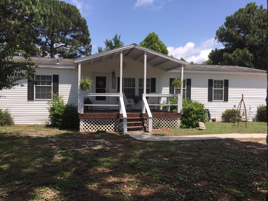 VERY NICE AND IMACULATE MOBILE HOME. LOCATED IN A QUIET AND VERY NICE NEIGHBORHOOD.  3 BR 2 BATH MOBILE HOME WITH VERY NICE LANDSCAPED YARD.  HUGE 12X28 SCREEN IN BACK PORCH.  BIG WORK SHOP ATTACHED TO A 2 CAR GARAGE, ALSO A SEPARATE STEEL CONSTRUCTED UTILITY SHED. ENJOY A SPACIOUS LIVING ROOM AND KITCHEN AREA. ROOF IS APPROXIMATELY 7 YEARS OLD AND A/C ABOUT 3.5 YRS. OLD. LAMINATE FLOORS, TILED BATHS AND OPEN FLOOR PLAN. SEPTIC LINES REPLACED ABOUT 4 YEARS AGO.  COVERED SWING IN BACK YARD AND ALSO ROOF OVER THE FRONT PORCH. WHICH INCLUDES 4 WHITE ROCKING CHAIRS SO YOU CAN RELAX AFTER A HARD DAYS WORK. YARD ALSO HAS A SIDE WALK CONNECTED TO THE CEMENT DRIVEWAY.  FINANCING OFFERED THROUGH 21ST MORTGAGE CORPORATION
