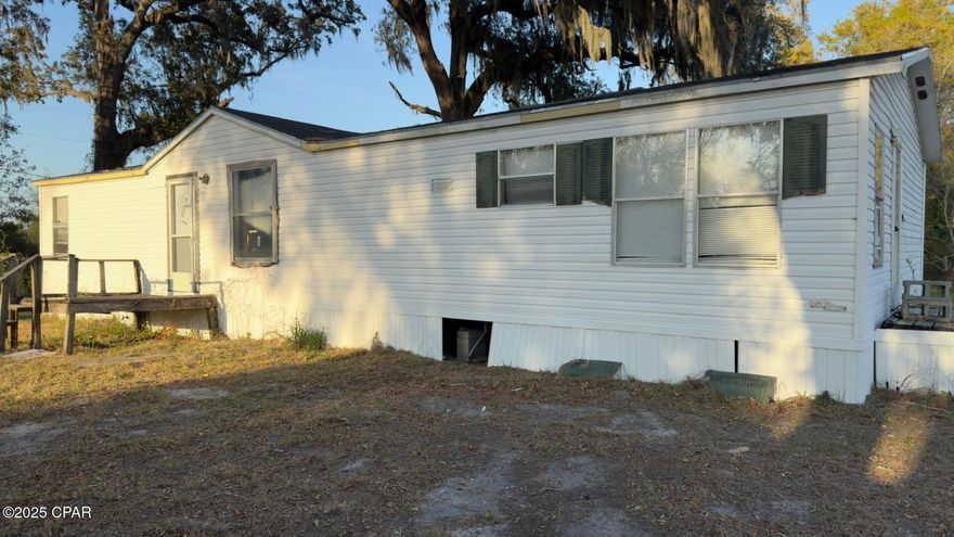 Great Investment Opportunity! This spacious 0.84-acre lot is tucked away in a peaceful neighborhood in the heart of Parker, just minutes from Tyndall Air Force Base and only 30 minutes to both Panama City Beach and Mexico Beach. The property includes a 1998 manufactured home (3 bed, 2 bath, 1,296 sq ft) that is not considered livable, providing a blank canvas for your next project. Whether you're an investor or someone looking to build your dream home, this oversized lot offers endless potential in a quiet, convenient location. No HOA. Don't miss this chance to own land in a growing area!