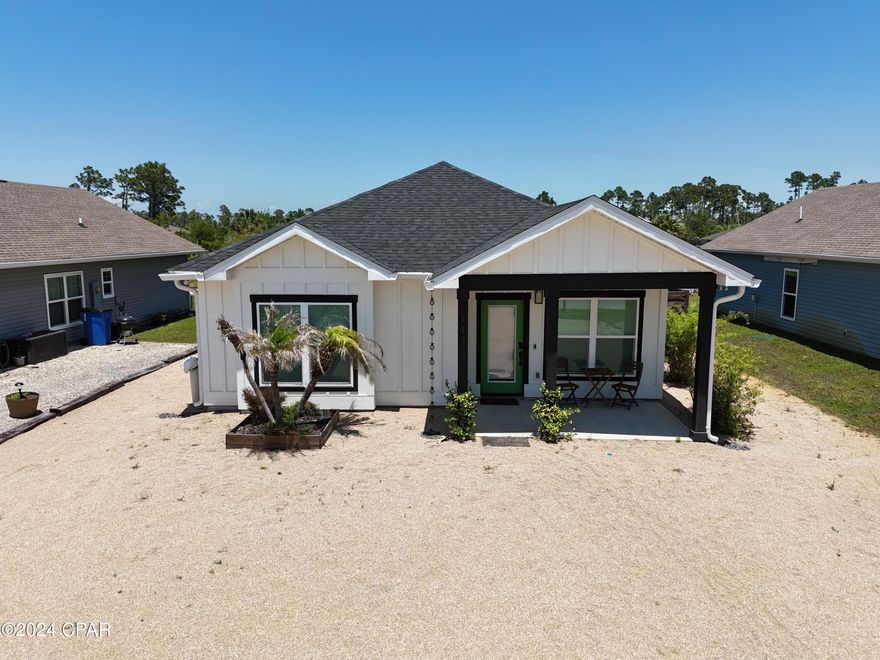 Under contract - taking backups! Just listed is an almost brand new home that is less than 3 years old and in fantastic condition. This home is very stylish and visually appealing inside and out. It sits on a large X flood zone lot in a neighborhood with no HOA fees that does allow short term rentals, if desired. Huge fenced in backyard with a large storage shed and a nice screened in back porch that includes a hot tub and outdoor tv. You'll enjoy LVP flooring throughout the home and a sleek kitchen with stainless appliances and quartz countertops. Very durable construction with board and batten hardy siding and a rocked front parking area that will require minimal landscaping upkeep. This home is sold completely furnished and equipped and is truly move-in ready. Home includes a fair amount of extras like an irrigation well, water filtration system, and a Rinnai hot water heater. Make sure to check out the virtual tour.