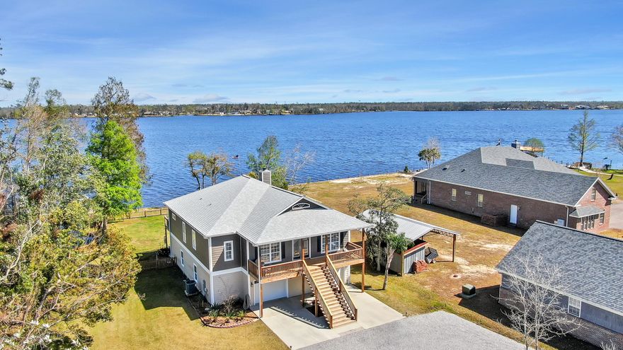 Beautiful sunrises await on this gorgeous lakefront home.  Whether you're looking for lake life, garage space or refined finishes, you can stop looking because this house has it all.  The home sits on approx. 1 acre with 100 ft of waterfront on Deer Point Lake. The first floor has a four-car oversized garage (odds are your boat will fit), plus workbenches, storage space and a heated/cooled 200 SF office that's not counted in overall sf.   Upstairs you'll find a bright and airy open concept LR/DR & Kitchen with windows and transoms galore, two sets of French doors to the screened porch with addt'l deck that runs the length of the house.  The kitchen is a cook's dream with double convection ovens, Quartz counters, 42'' solid wood cabinets, under cabinet lighting, breakfast bar, pantry and lots of storage. The split plan master suite is huge with French doors to the deck and the master bath has a luxurious walk-in shower with three showers heads/four body jets, seamless glass, a separate tub, a water closet, dual sinks and large linen closet.  There are two addt'l bedrooms, hall bath with subway tile surround and a laundry room with custom cabinetry and laundry sink. There are three garage doors, a fenced backyard with cedar picket fence and sprinkler system using lake water.  Don't wait,call your favorite Realtor to set up a showing today and ask for a list of all the upgrades this home has to offer.