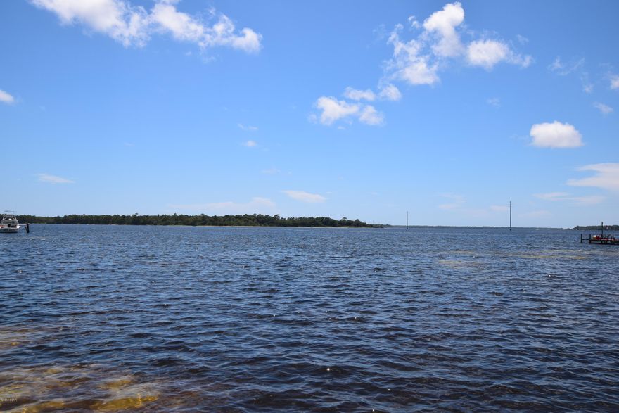 One of the prettiest Bay front lots in Bay County! Gorgeous old growth oaks covered in Spanish Moss.  120ft on the bay. The brick home needs some TLC, but for this price you'll have plenty in the budget for renovation. The home is high and dry so you'll even save on the insurance.  Renovate the apartment above the workshop and have a rental income as well.  Here's your opportunity to own a bay front property!