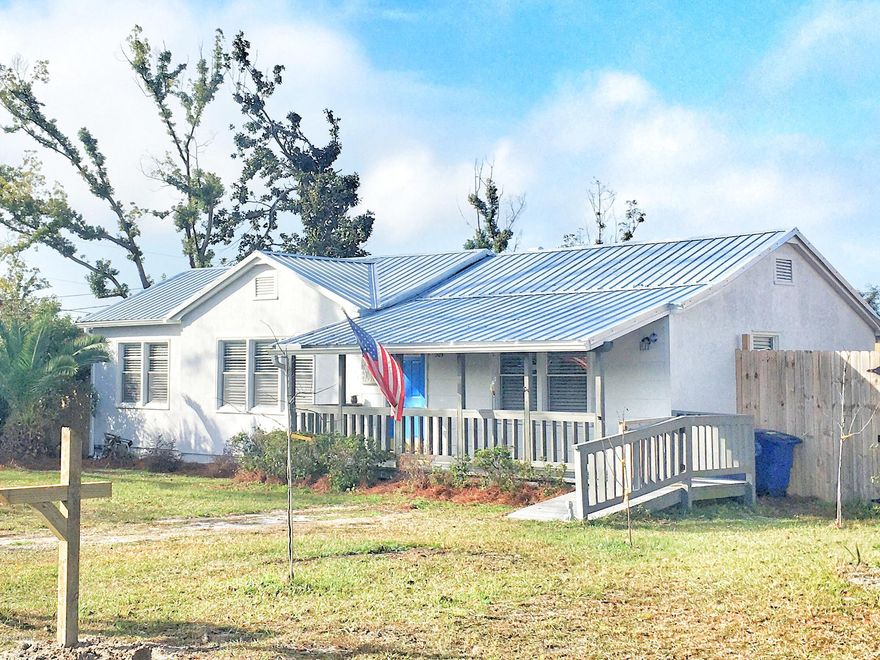 Adorable WWII-era Cove Bungalow, beautifully updated for modern living. This sturdy home sustained very little damage (now repaired) in H Michael, partly due to its 2017 metal roof & solid construction. You'll love the wide, covered front porch, the deep privacy fenced 1/4 acre lot w/ alley access & sliding gate, the awesome workshop & carport, and 12x18 screened back porch (could be enclosed for additional living space). Inside is a modern split bedroom floorplan, gorgeous original hardwood flooring, and new fixtures & ceiling fans. The eat-in kitchen has brand-new stainless appliances, granite countertops, pantry, & laundry closet. Master suite boasts cathedral ceiling, garden tub, walk-in closet. Super-convenient to shops, dining, & activities of Historic Downtown