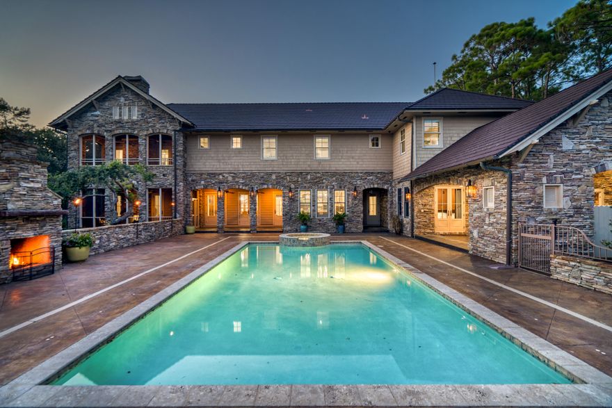 JUST REDUCED!  Discover unmatched luxury at this breathtaking lakefront estate with enormous pool & spa in the gated Wild Heron community on Lake Powell with spectacular water vistas throughout. A short boat ride from your private dock through Florida's largest & loveliest coastal dune lake brings you to a stunning, isolated beach. Designed for entertaining, elegant spaces welcome gathering & relaxation including a media room with movie screen, a walk-in wine cellar & full-size bar. The spacious first level living area is highlighted by coffered ceilings & a gorgeous stone hearth fireplace while a study & office provide thoughtful spaces to work. The dining room includes exposed beams, arched entryways & stately columns. The gourmet kitchen has triple granite counters, a gas 6-burner Viking stove with lights & double oven, Viking double refrigerator, farmhouse porcelain sink, & breakfast area. The second level master suite is a true sanctuary with an indoor/outdoor gas fireplace & a private covered screened porch with picturesque views of the lake, pool & impeccably landscaped grounds. Highlights of the master bath include an oversized Jacuzzi tub, separate walk-in shower & separate granite vanities. Expansive his & hers closets the size of a bedroom feature custom shelving & ample storage. Five additional bedroom suites include a large living area/bedroom over the oversized five-car garage that would make the perfect mother-in-law suite with private entry. The enchanting backyard is centered around the heated swimming pool & features a fireplace & outdoor kitchen, all overlooking the 180' of lakefront with private dock & boatlift.
Wild Heron is a private community on 734 acres conveniently located along the shores of Lake Powell. Homeowner amenities include the BoatHouse on Lake Powell, a beautiful community swimming pool & a state-of-the-art fitness center. Membership opportunities are available to join Shark's Tooth Golf Club, a private Greg Norman-designed golf club is located within the community with a five-fairway course, clubhouse, restaurant & tennis courts. Do not miss this rare offering!