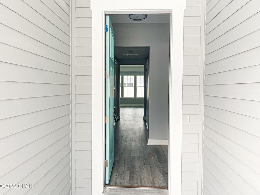 Welcome to Breakfast Point! This brand new Samuel Taylor Built Trigger floor plan is move in ready and never lived in! This home boasts gorgeous gray tone luxury vinyl plank flooring in the main living areas, white cabinets, under cabinet lighting, subway tile backsplash, quartz countertops, carrera marble looking tile in the bathrooms, subway tile surround walk in shower in the master bath, double vanity and walk in closet. Huge covered back porch and plenty of room for a pool. This home is built above current hurricane codes with 2x6 exterior wall framing, hurricane tie down rod and anchor system, architectural shingles and hurricane screens for the windows.