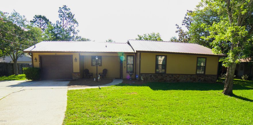 Beautiful home nestled in the heart of the desirable Lynn Haven area.  With exposed beams stretching across the vaulted living room ceiling and a cozy fireplace, a large updated custom kitchen with stainless steel appliances, tile back splash and bay windows in the dining area, this home has plenty of charm.  Situated on two full lots, there is plenty of backyard space for children, guests, pets and even room to install a large pool for these hot summer months!  Also, there is a huge detached garage with enough room for multiple cars and all the work space you could ask for.  Tiki bar and hot tub! Roof is  4 years old and A/C in just a few years old. Home also has a tankless water heater, and new insulation! Under contract but taking back up offers.